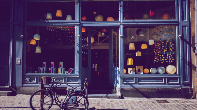 Image of a bike outside a shop on a quiet street